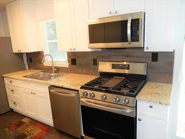 a kitchen with a stove and a microwave