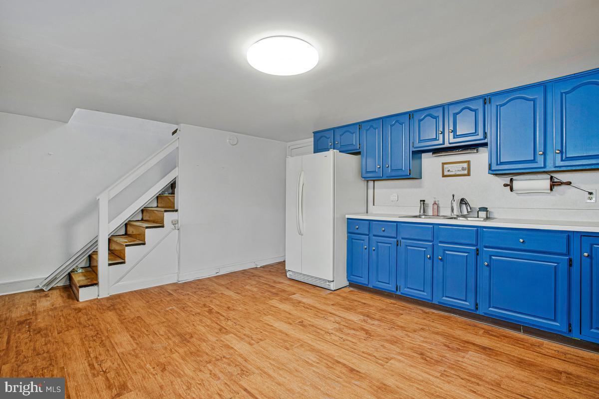 3040 Federal Street Baltimore, MD 21213 - Photo 29 of 41 a kitchen with granite countertop wooden cabinets and white appliances