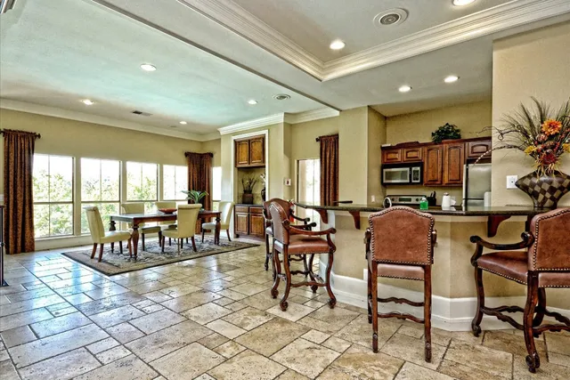 a room with lots of chairs and view of living room