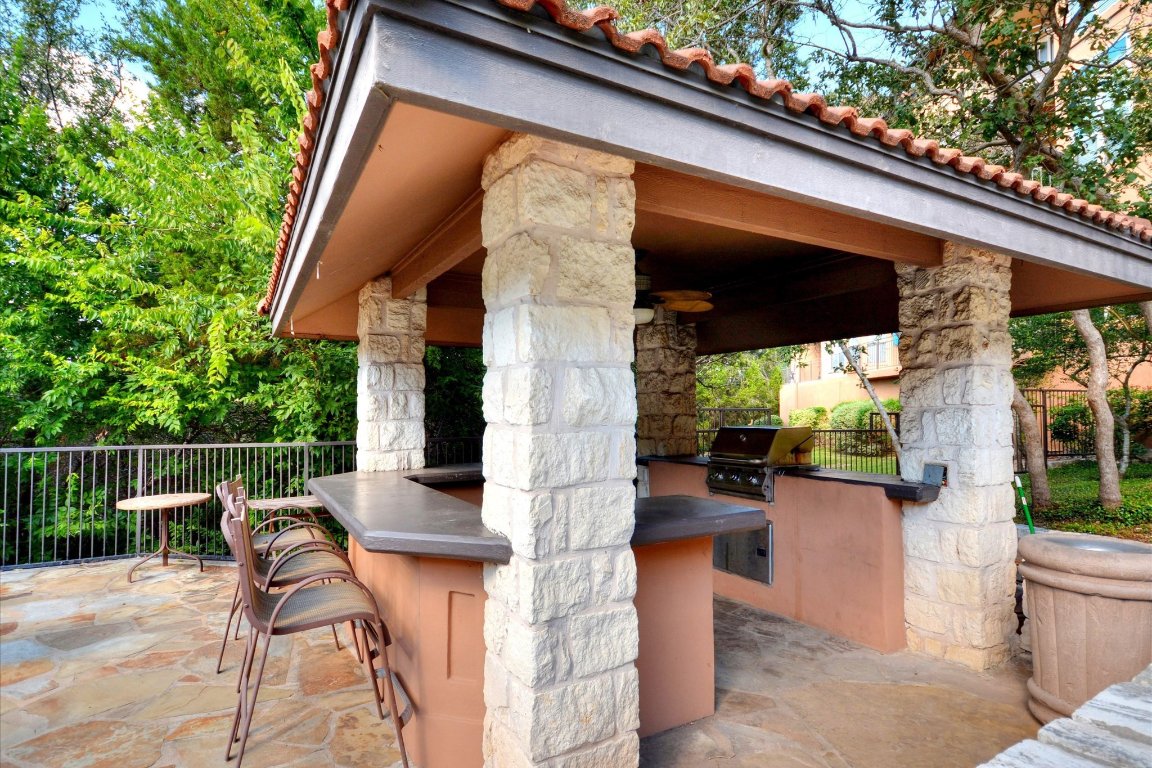 6000 Shepherd Mountain Cove, Unit 1805 Austin, TX 78730 - Photo 20 of 20 a view of a patio with table and chairs and potted plants