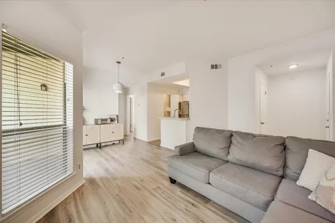 a living room with furniture and kitchen view