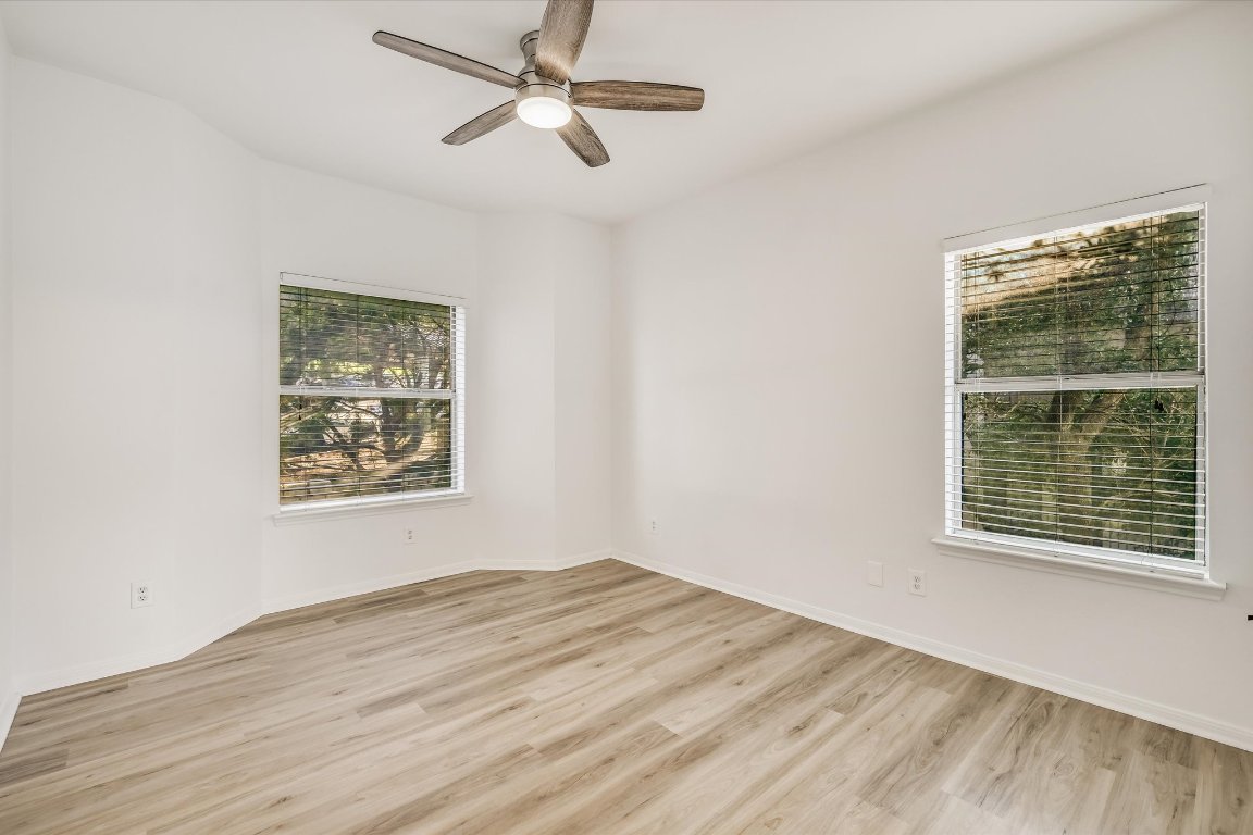 6000 Shepherd Mountain Cove, Unit 1805 Austin, TX 78730 - Photo 8 of 20 a view of an empty room with wooden floor and a window