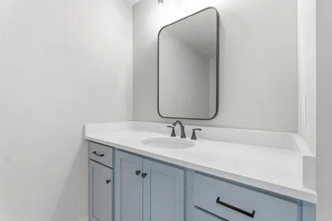 a bathroom with a sink and a mirror