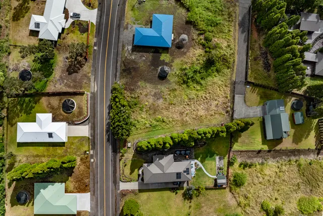 an aerial view of a house with a yard swimming pool