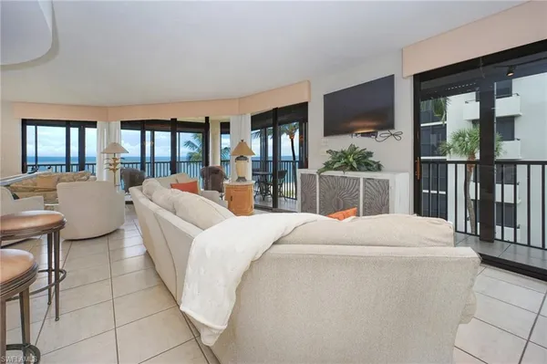a kitchen with stainless steel appliances granite countertop a table chairs sink and cabinets