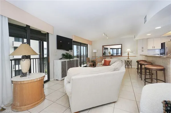 a dining room with furniture and large windows