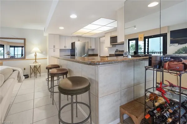 a kitchen with stainless steel appliances a stove refrigerator sink and cabinets