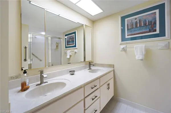 a bedroom with two beds and next to a window