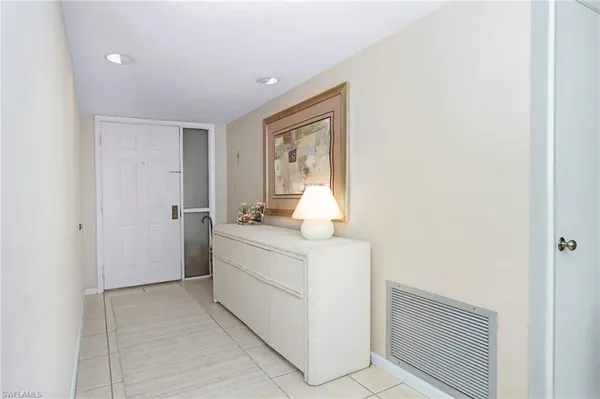 a living room with furniture fireplace and a large window