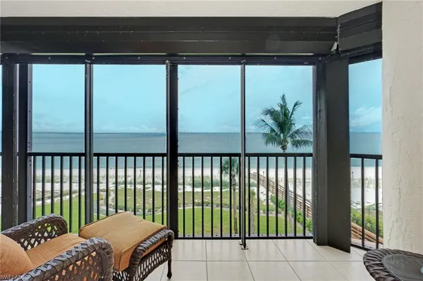 a living room with furniture and a floor to ceiling window