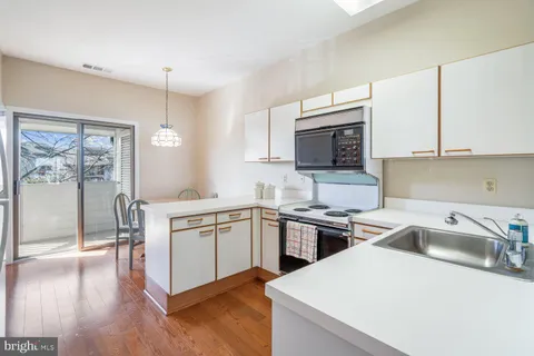 a kitchen with stainless steel appliances granite countertop a sink stove and microwave