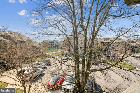 a view of a balcony with wooden floor and fence