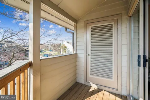 a bedroom with a bed a couch and a chandelier