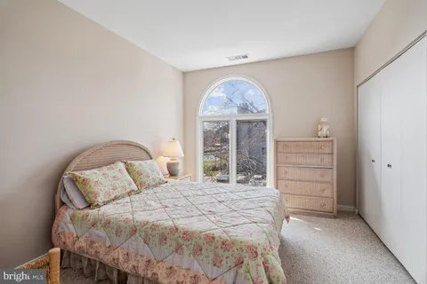 a bedroom with a bed and a closet