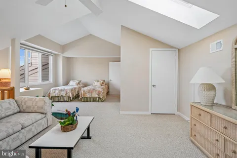 a living room with furniture and a night stand
