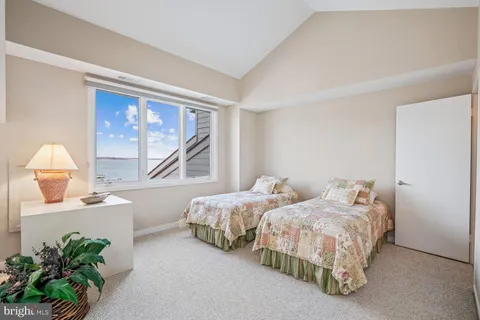 a bedroom with a large bed and a large window