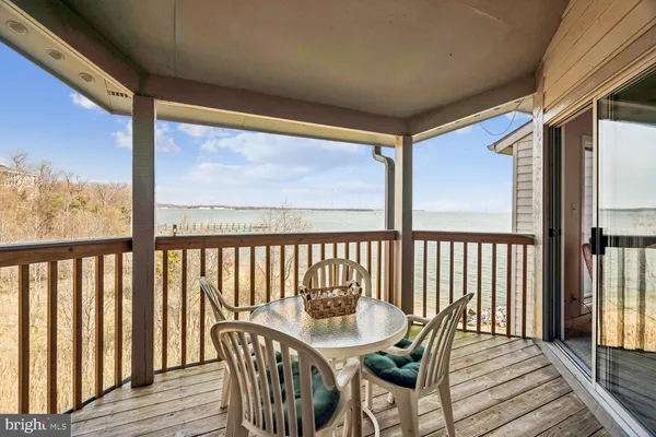 a view of a chairs and table in the balcony