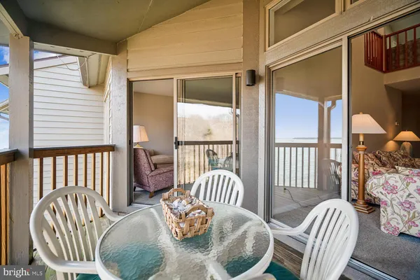 a view of a chairs and a table in the balcony