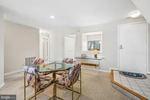 a living room with furniture and a lamp