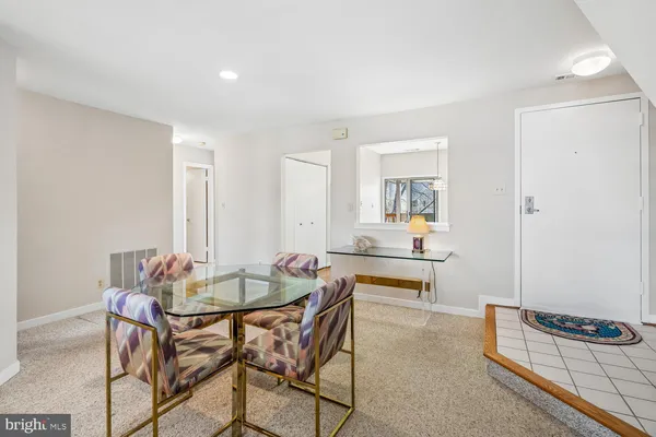a living room with furniture and a lamp