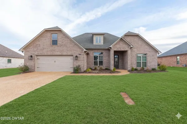 a front view of a house with yard