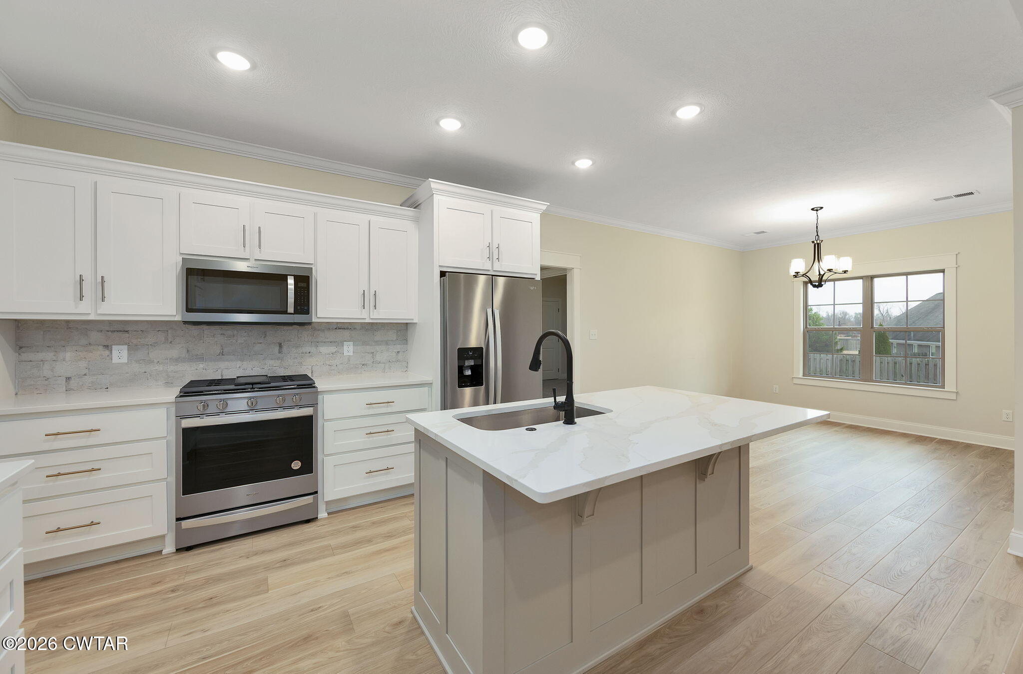 126 Isaiah Drive Jackson, TN 38305 - Photo 14 of 32 a kitchen with a sink stove and microwave