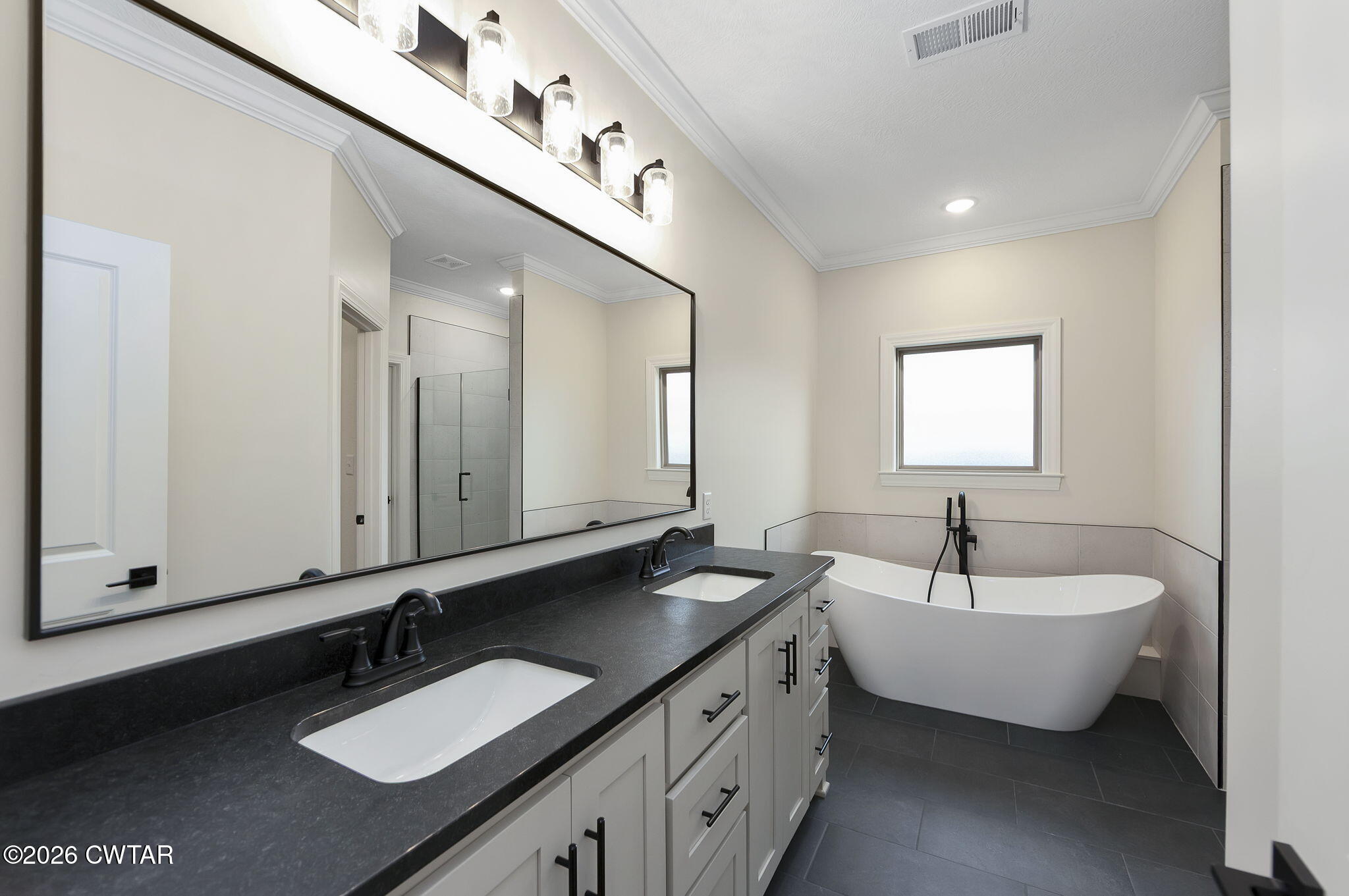 126 Isaiah Drive Jackson, TN 38305 - Photo 17 of 32 a spacious bathroom with a double vanity sink and mirror