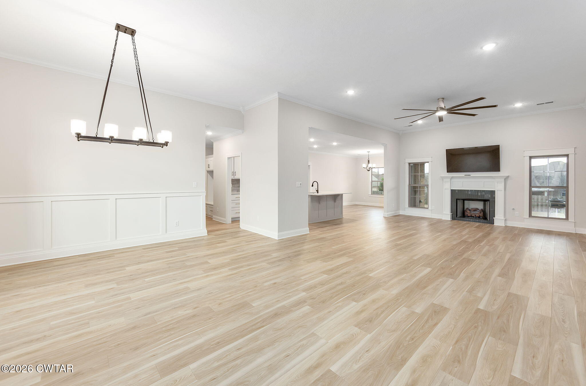 126 Isaiah Drive Jackson, TN 38305 - Photo 2 of 32 a view of a livingroom with a fireplace a flat screen tv and a chandelier