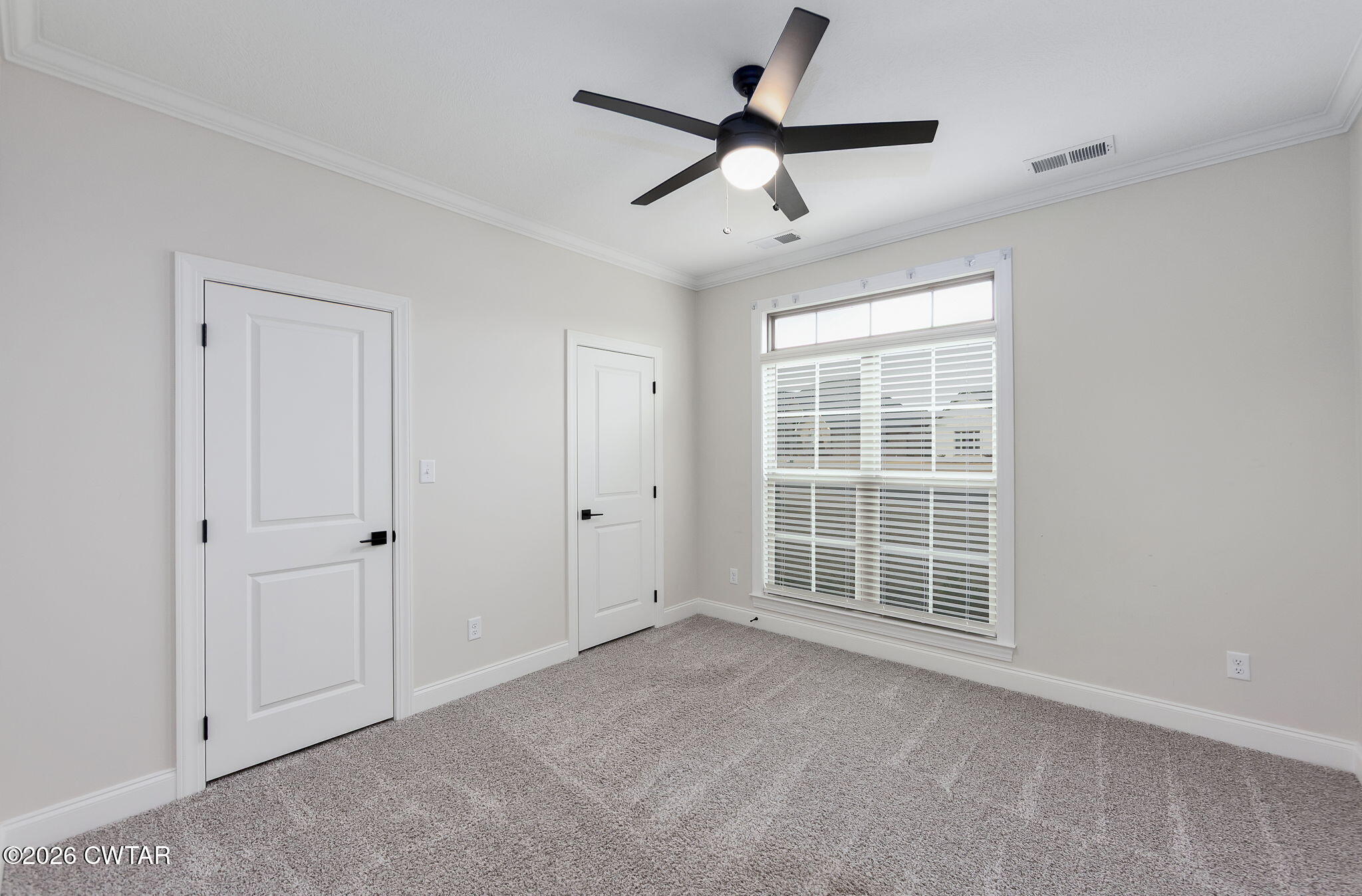126 Isaiah Drive Jackson, TN 38305 - Photo 21 of 32 an empty room with ceiling fan and windows