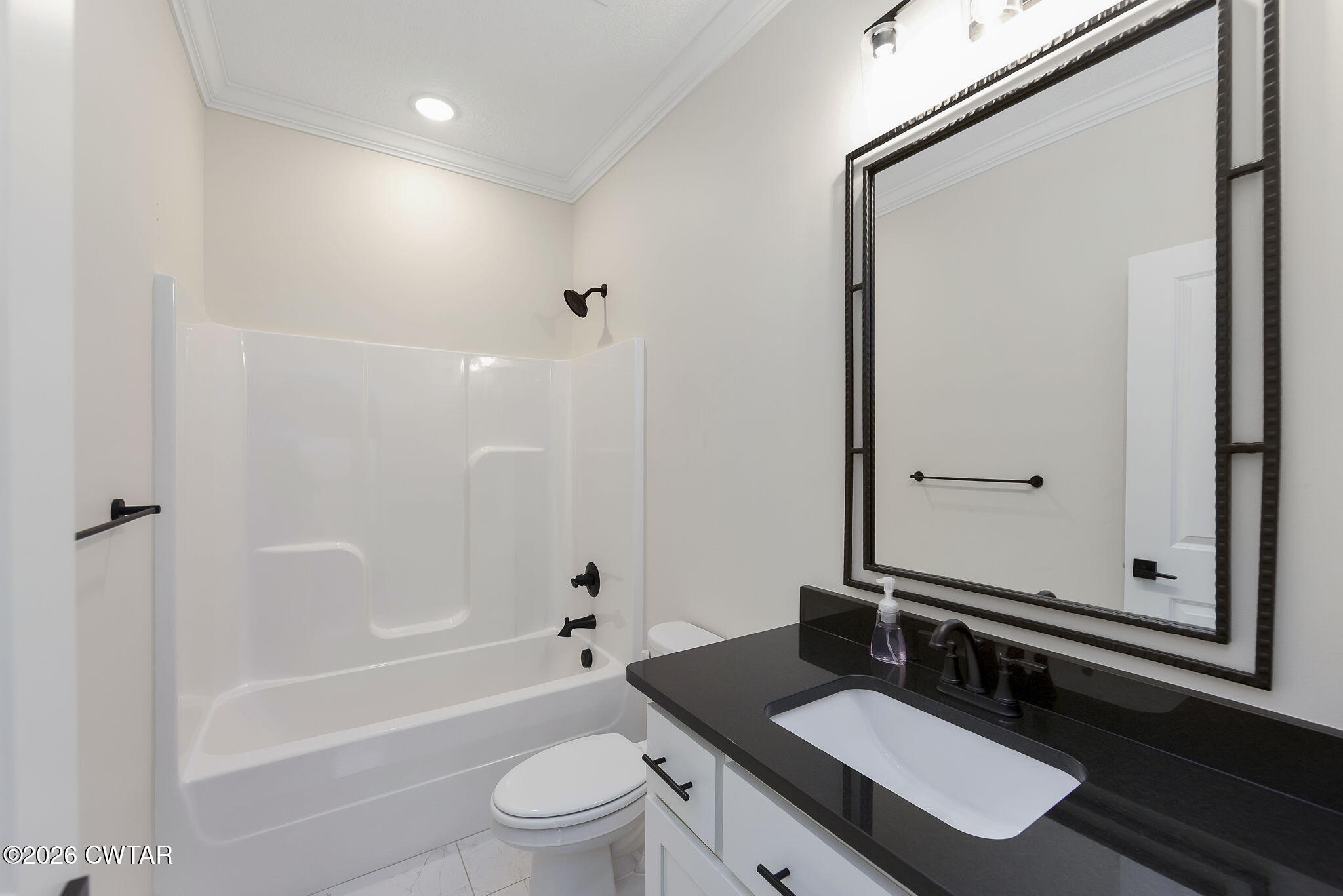 126 Isaiah Drive Jackson, TN 38305 - Photo 24 of 32 a bathroom with a granite countertop sink toilet a mirror and shower