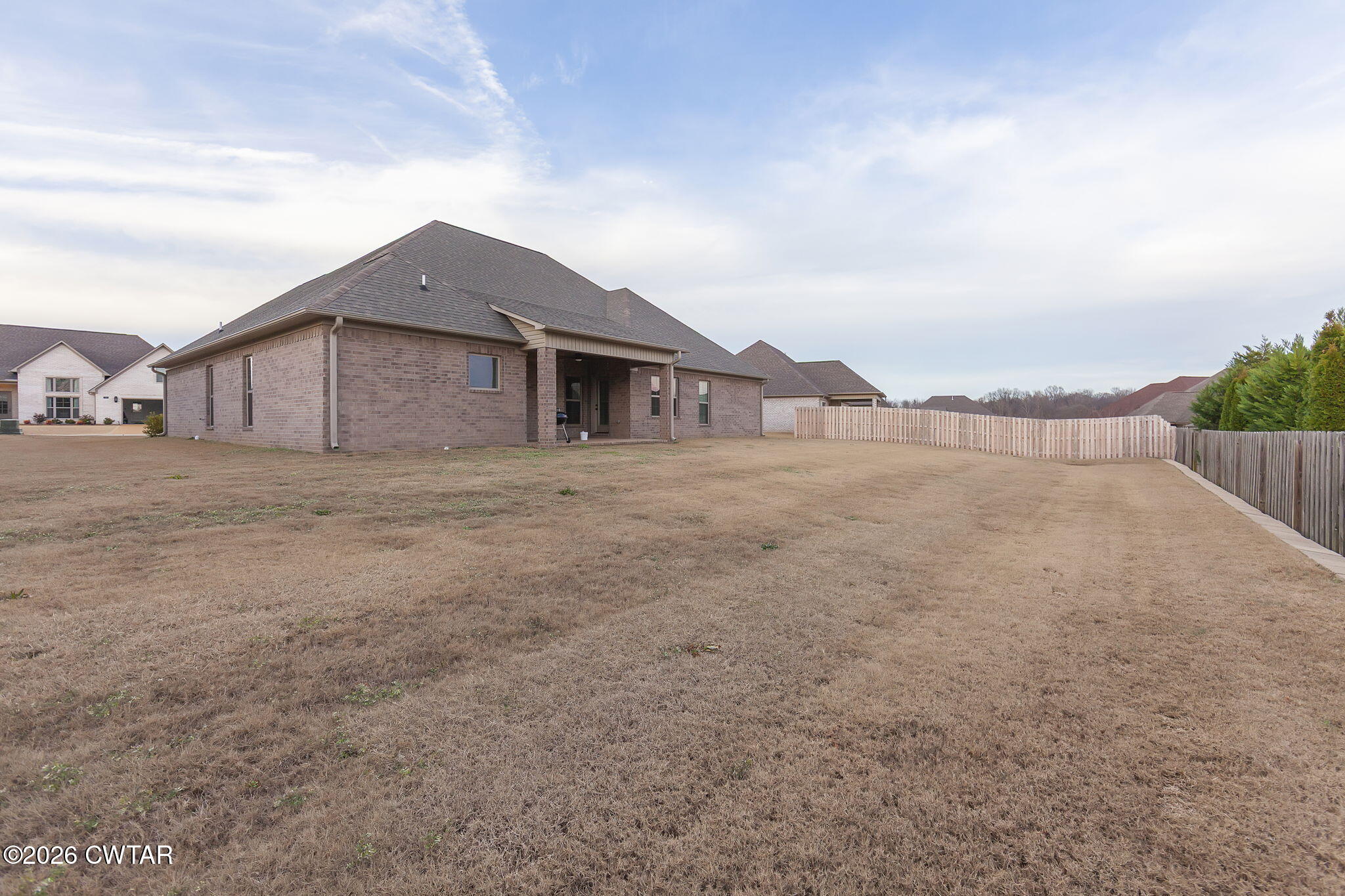 126 Isaiah Drive Jackson, TN 38305 - Photo 30 of 32 a view of a house with a big yard and large tree