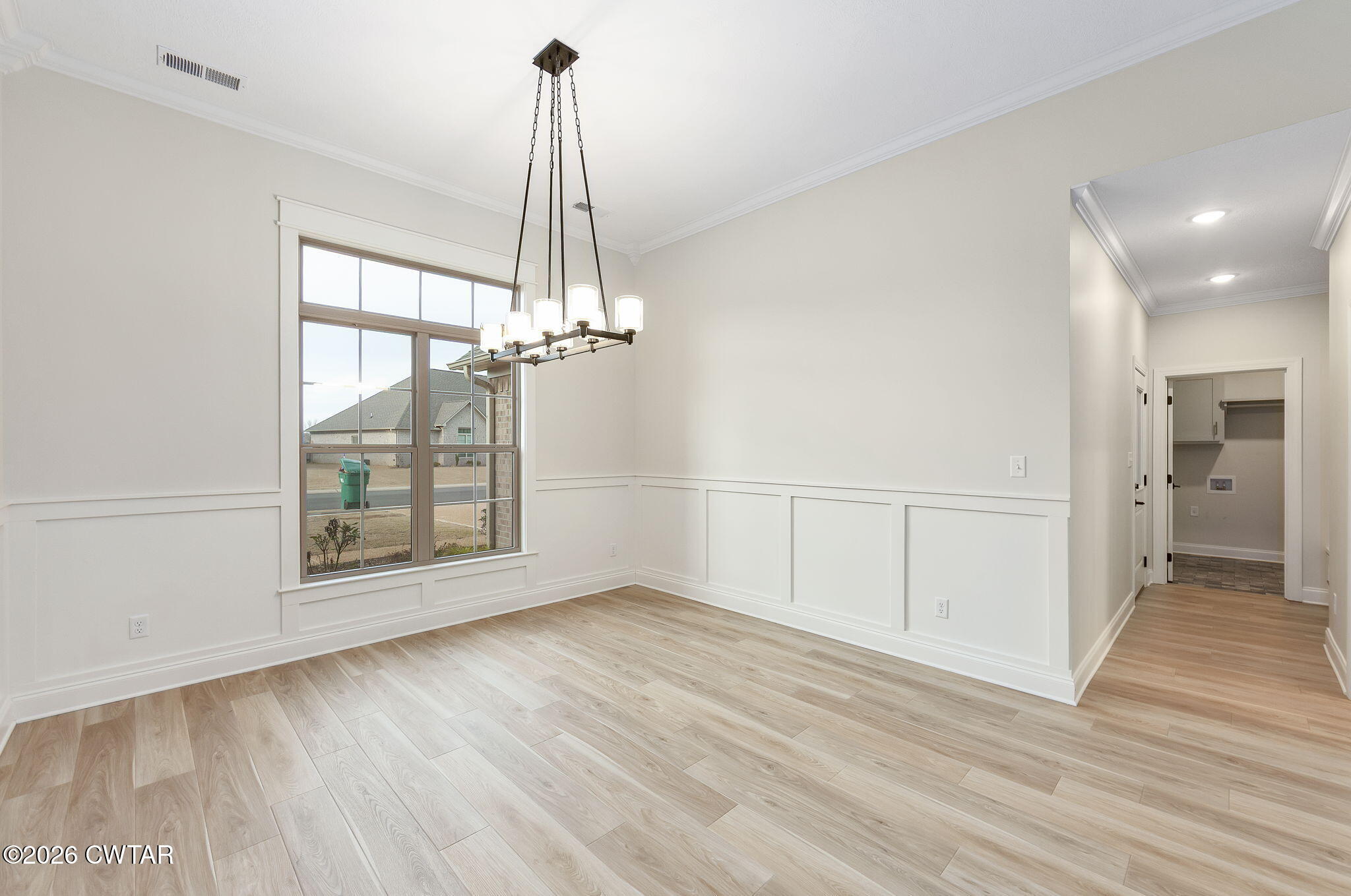 126 Isaiah Drive Jackson, TN 38305 - Photo 3 of 32 a view of an empty room with wooden floor and a window