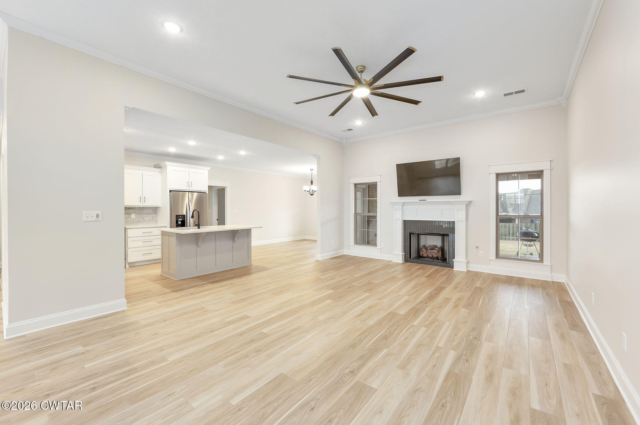 126 Isaiah Drive Jackson, TN 38305 - Photo 6 of 32 a view of a kitchen with a sink a fireplace and wooden floor