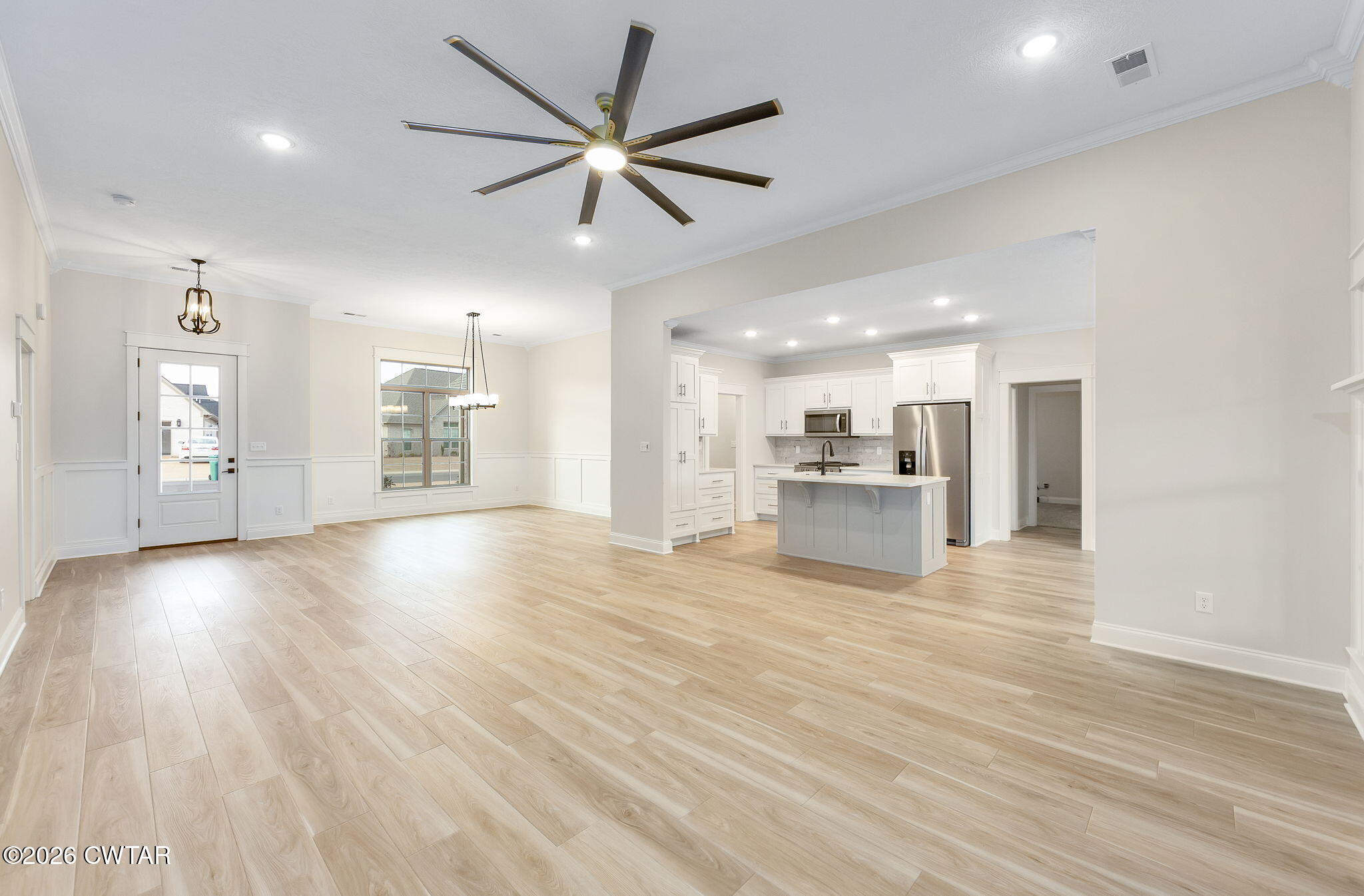 126 Isaiah Drive Jackson, TN 38305 - Photo 7 of 32 a view of an empty room with a window and wooden floor