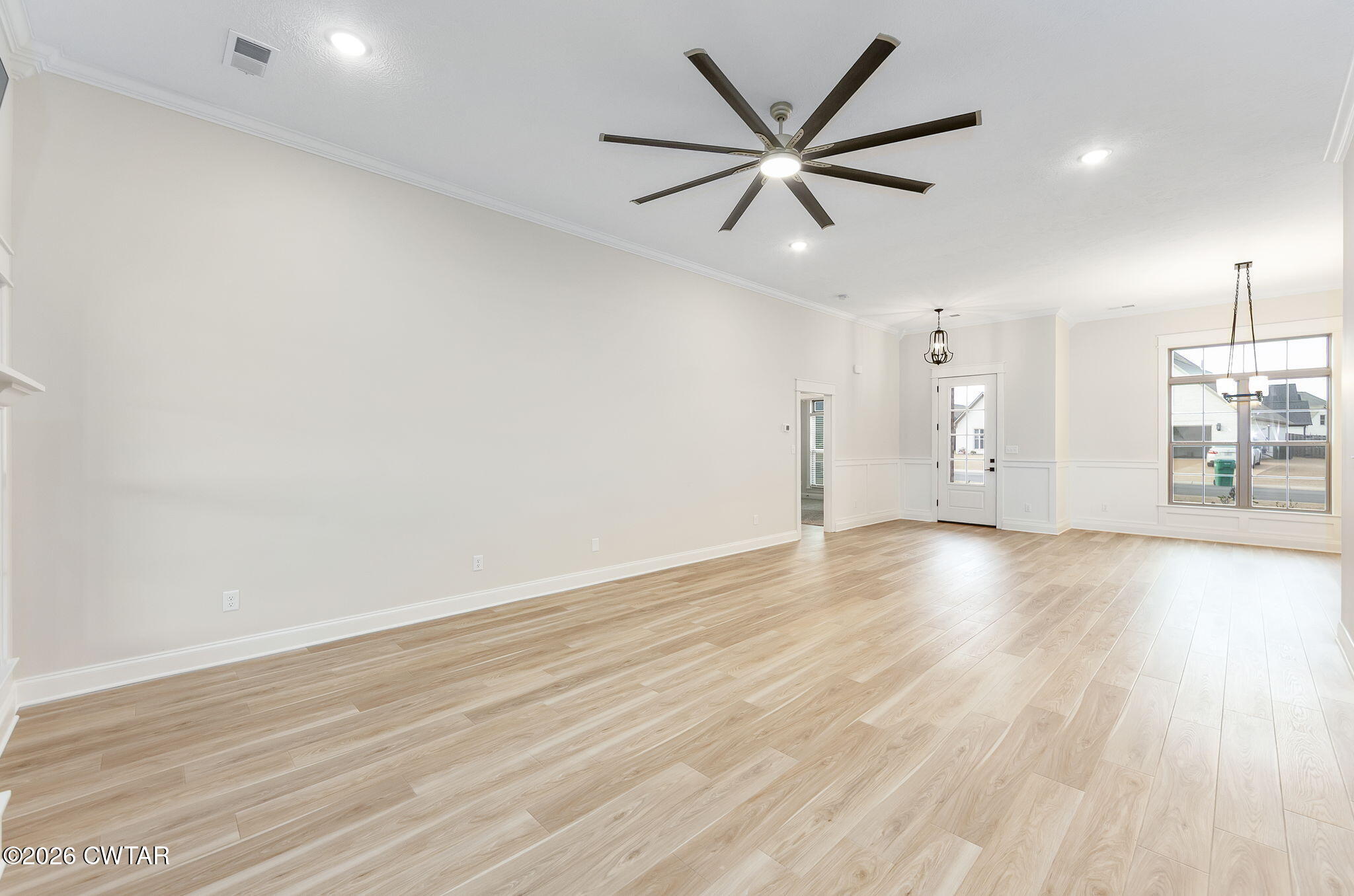 126 Isaiah Drive Jackson, TN 38305 - Photo 8 of 32 an empty room with wooden floor and windows