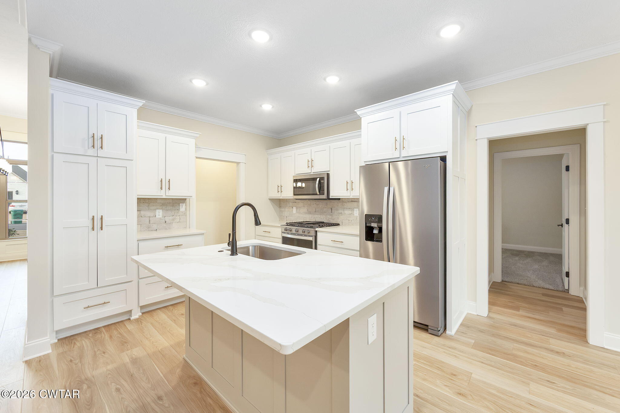 126 Isaiah Drive Jackson, TN 38305 - Photo 9 of 32 a kitchen with stainless steel appliances a refrigerator sink and cabinets
