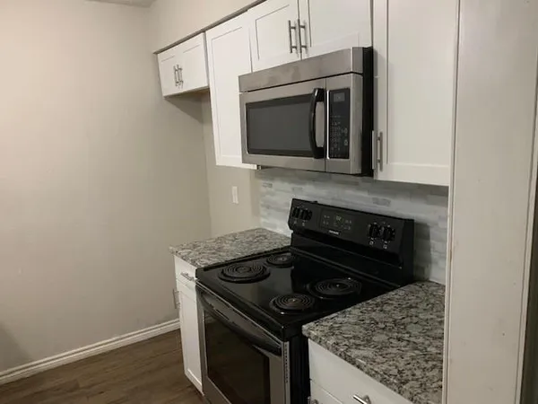 a kitchen with a stove and a microwave