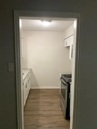 a view of a hallway with wooden floor