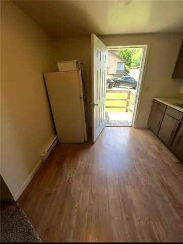 a view of a room with wooden floor and a window