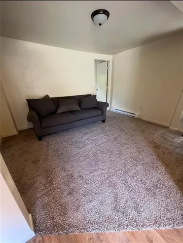 a living room with furniture and a rug
