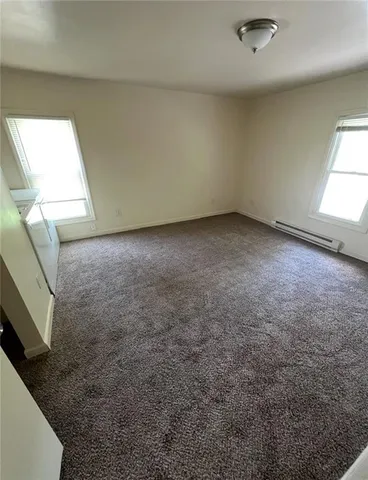 a view of an empty room and a window