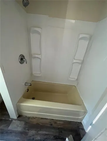 a bathroom with bathtub and shower