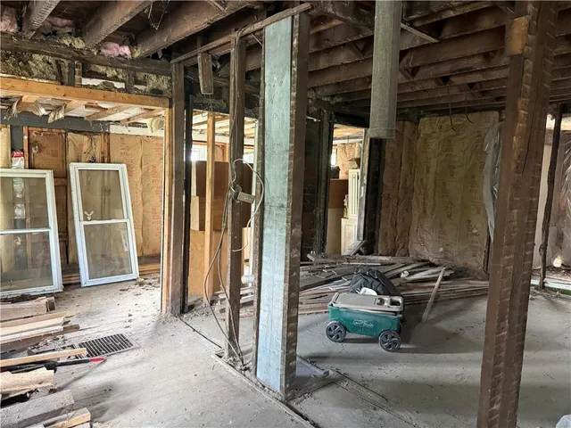 a backyard of a house with sofas table and chairs