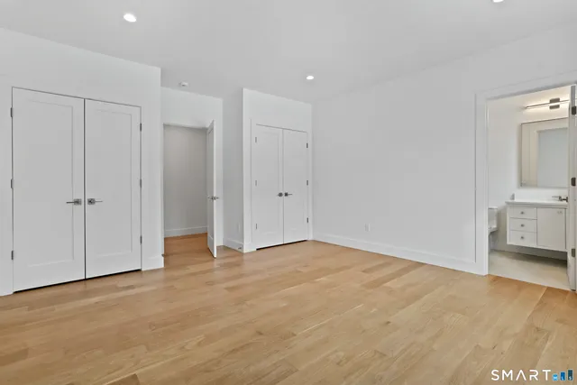 a bathroom with a sink toilet vanity and shower