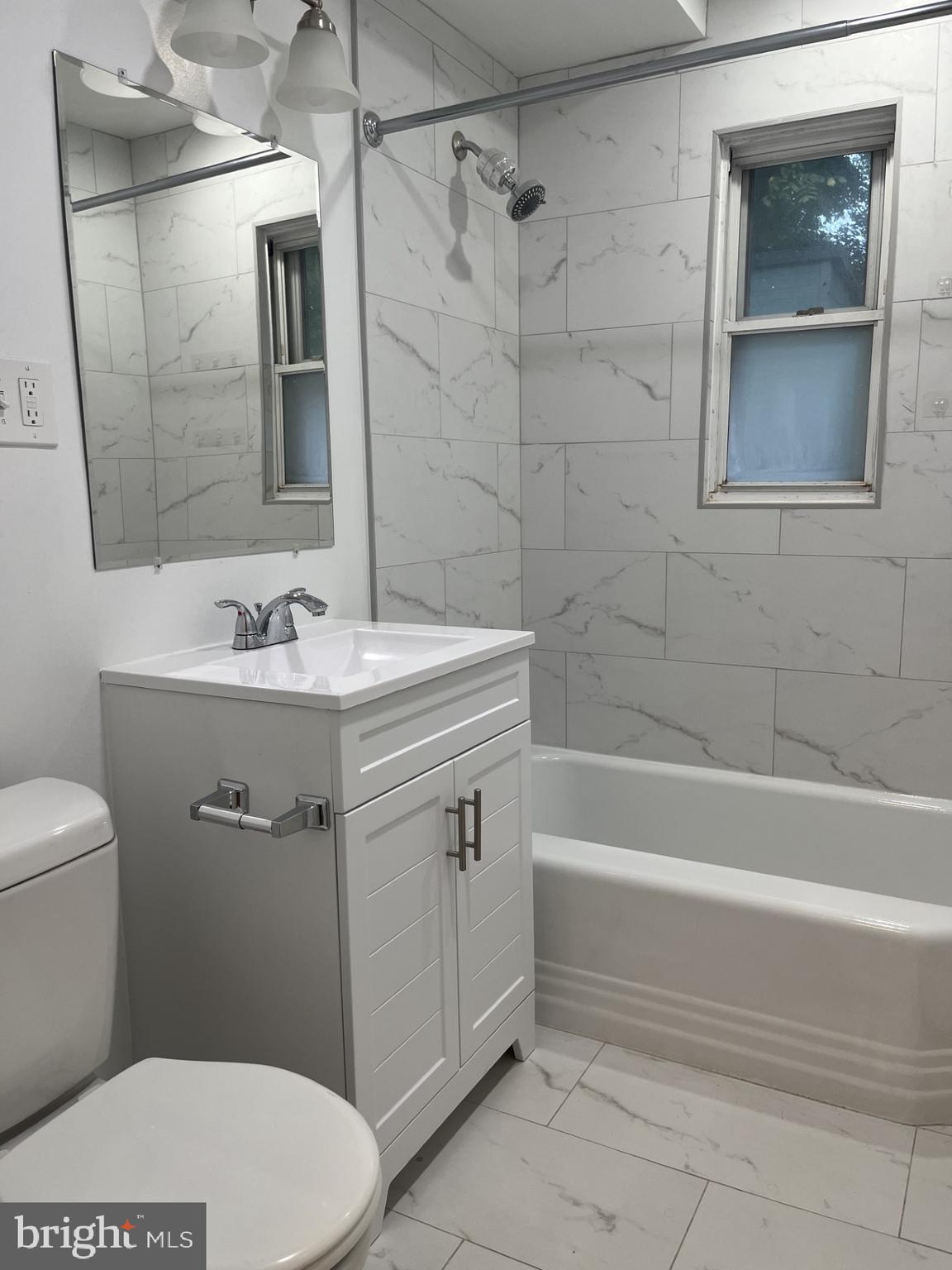 912 Prospect Street, Unit P1 Takoma Park, MD 20912 - Photo 1 of 8 a bathroom with a sink a toilet and shower