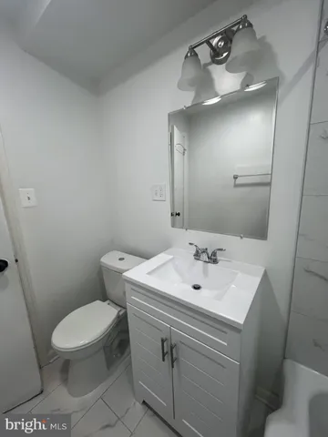 a bathroom with a sink a toilet and mirror