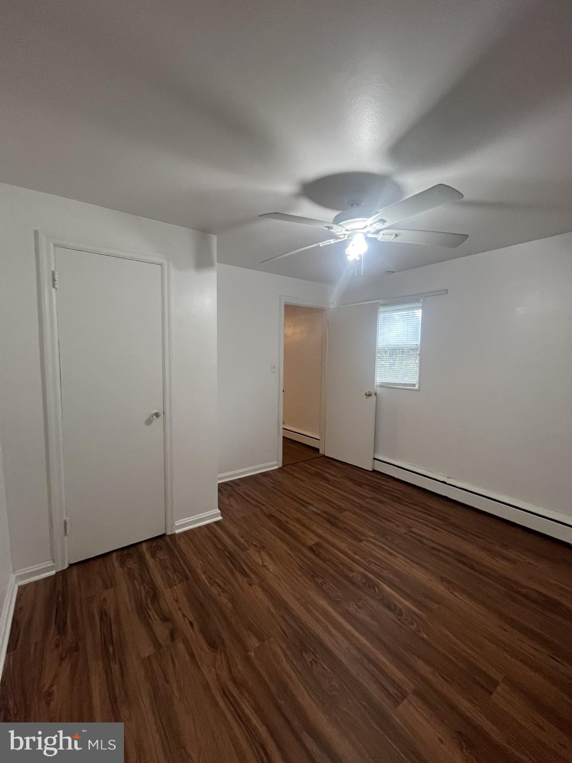 912 Prospect Street, Unit P1 Takoma Park, MD 20912 - Photo 5 of 8 a view of an empty room with wooden floor and a window