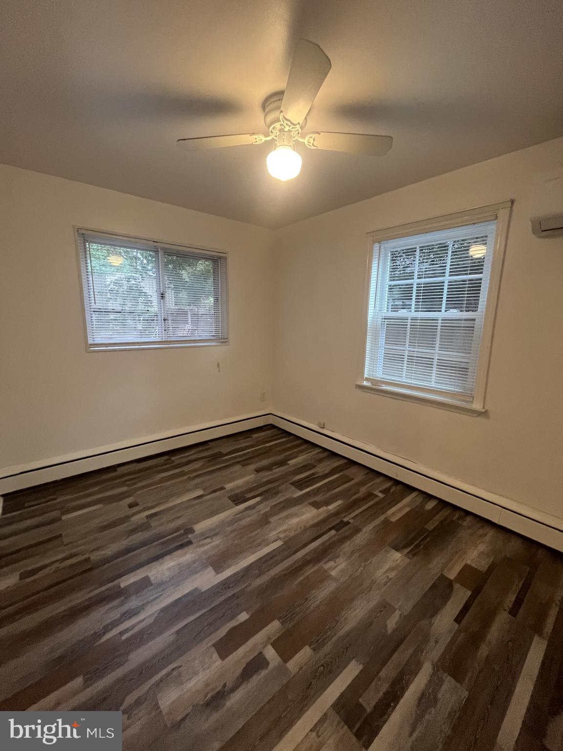 912 Prospect Street, Unit P1 Takoma Park, MD 20912 - Photo 6 of 8 a view of an empty room with wooden floor and a window