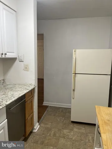 a kitchen with a refrigerator and a stove
