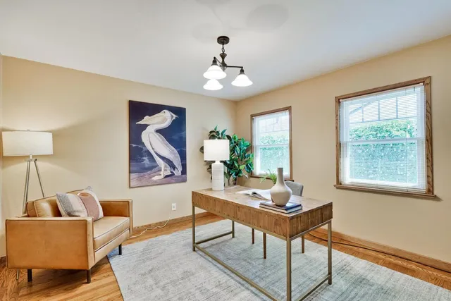 a living room with furniture a window and a chandelier